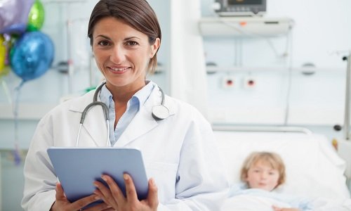 physician makes notes during hospital visit